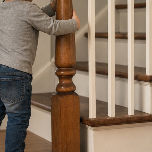 Young child examining house with magnifying glass — detail
